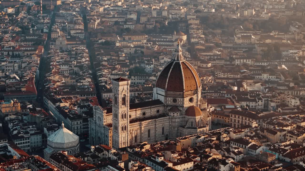 Descending pan up of Florence Duomo bathed in warm sunrise light