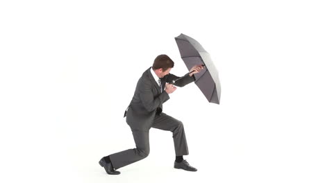 businessman opening umbrella and struggling