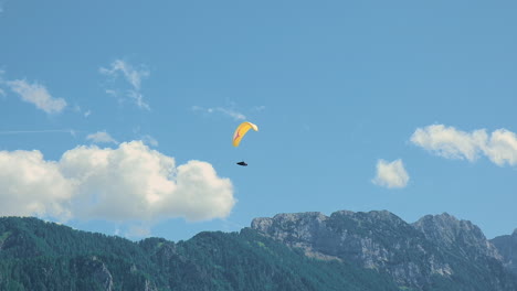 flying in the mountains, paraglider in alpine landscape, freedom and adventure concept, adrenaline sport, logar valley in slovenia