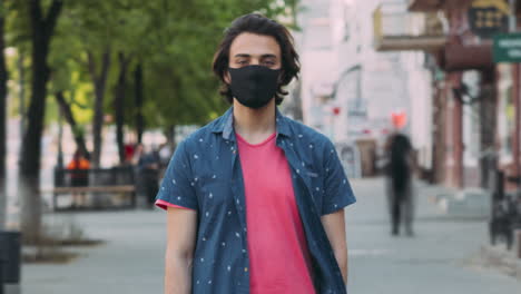 young man wearing mask in urban setting