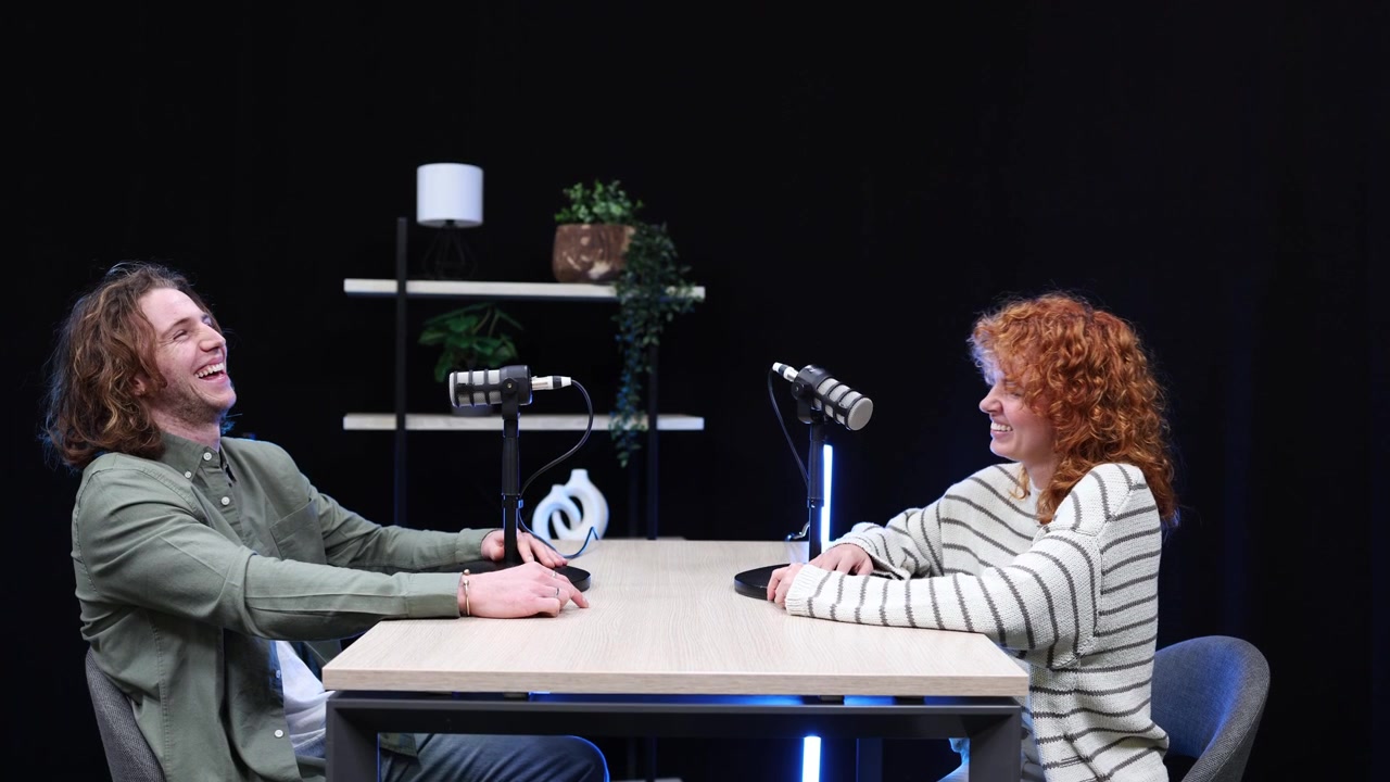 Young Man and Woman Laughing During a Podcast Interview
