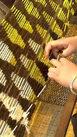 artisan weaving silk in khao yai, thailand