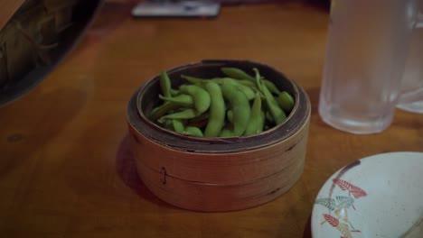 edamame soybeans revealed in traditional bamboo basket