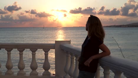 woman watching sunset from balcony