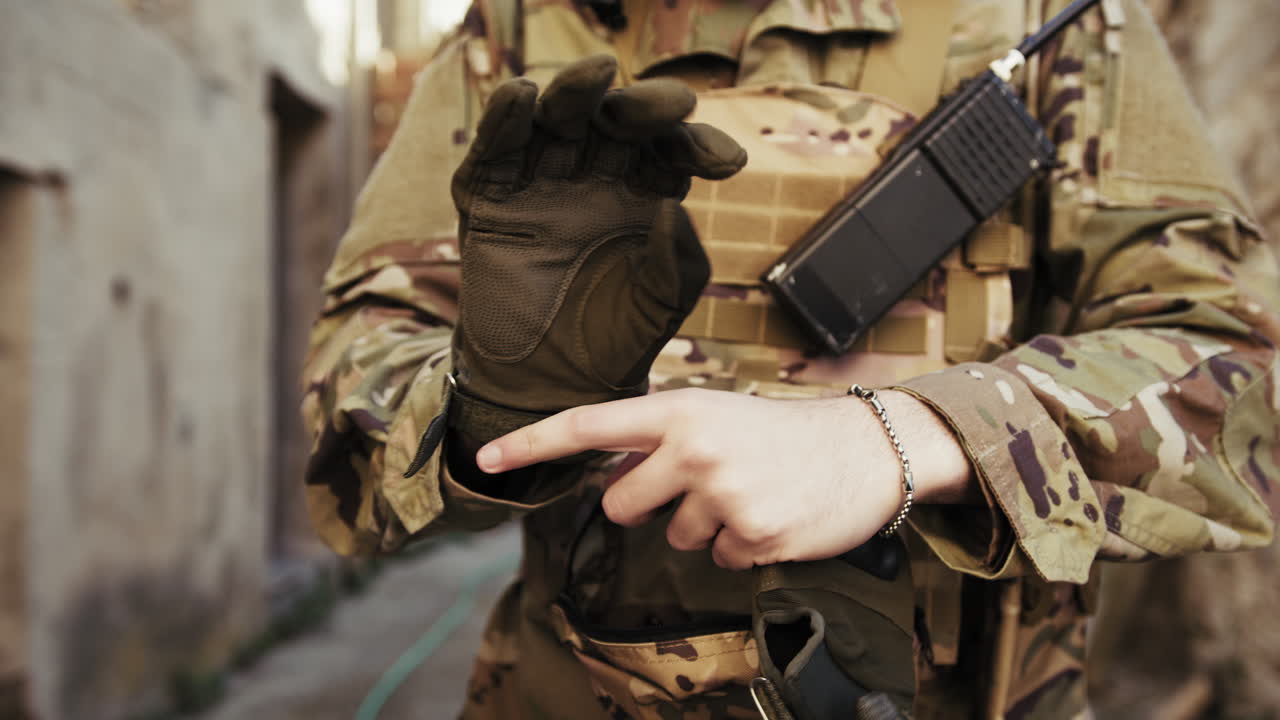 Soldier Puts On Gloves Before Starting The Operation In The City