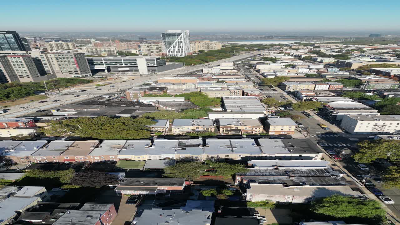 Circular aerial motion above Jersey City capturing rooftop variations, spaced structures, and connected streets