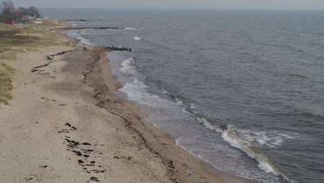 slow drones fly over the beach and the sea makes light waves