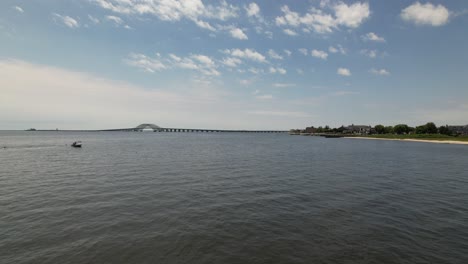 A-low-angle-view-of-the-Great-South-Bay-Bridge-starting-from-the-grassy-shore-on-a-beautiful-morning