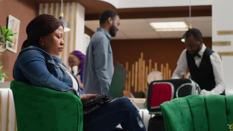 traveller sitting in lobby with laptop