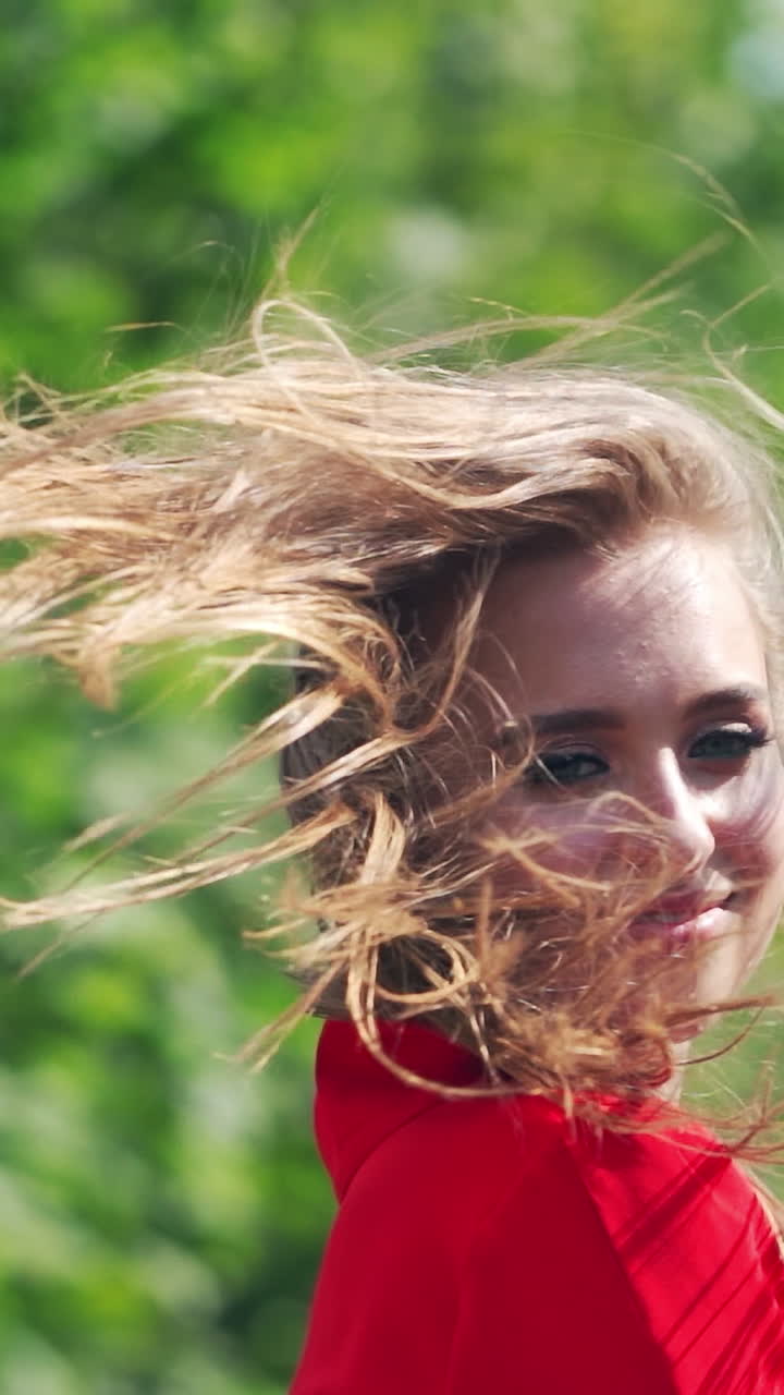 Portrait of beautiful woman. Happy woman in dress walking outdoors. Vertical video