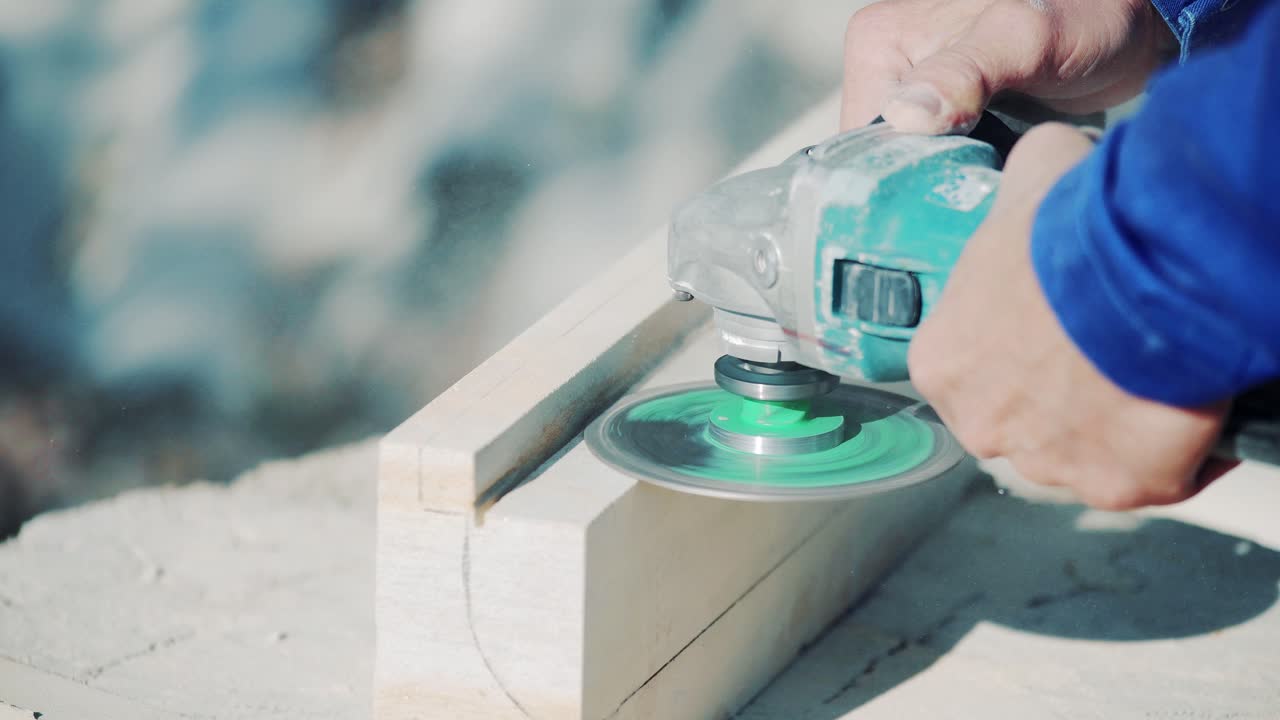 The master works with a stone using a grinder. Polishing and grinding of stone products. Close-up