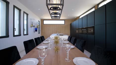 slow dolly shot of a prepared dining table with glasses and cutlery