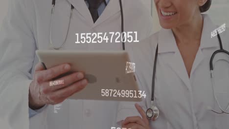 Animation-of-changing-number-over-caucasian-male-and-female-doctors-using-digital-tablet-at-hospital