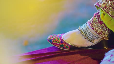 a beautiful close up of foot of an indian bride during photo shoot having anklet