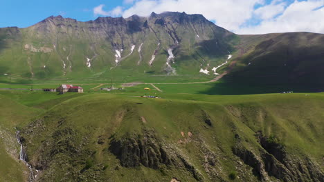 wide drone shot of paraglider in the mountains of gudauri georgia