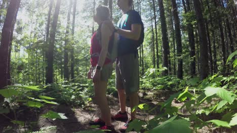 couple pointing out at distance in the forest 4k