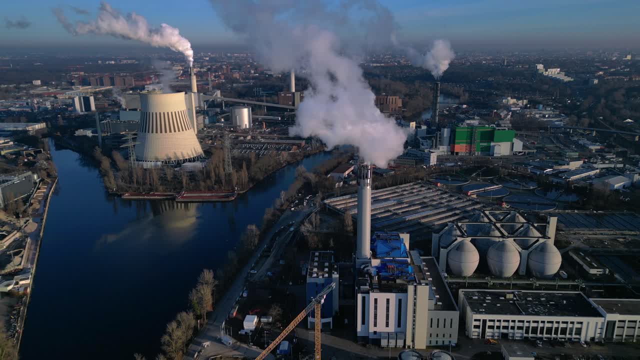 Industrial chimneys releasing large plumes of smoke pollution into the atmosphere, contributing to environmental damage. speed ramp hyper time lapse Dramatic aerial view fly through forward drone