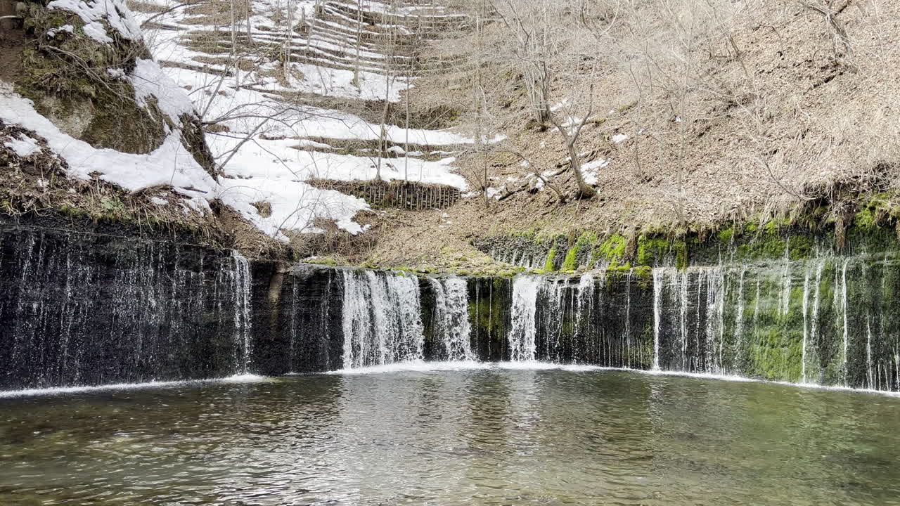 Handheld video footage of Shiraito Waterfall of Nagakura, Karuizawa, Nagano on late winter. The waterfall resembles white threads.