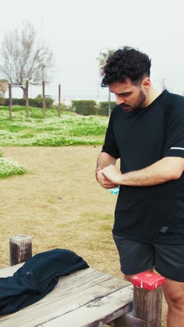 man drinking from a bottle during a break from outdoor training