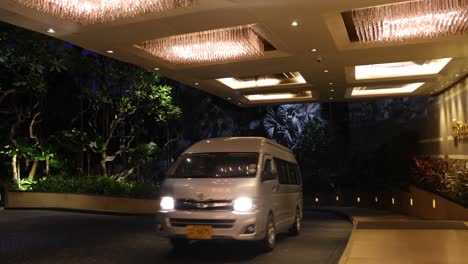 various vehicles entering and exiting a posh hotel