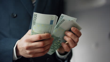 hands holding european currency close up. business man counting euro banknotes.