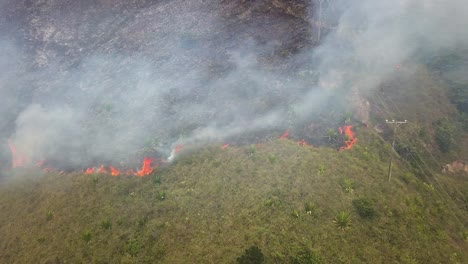 aerial dolly right of fire and heavy smoke near power poles