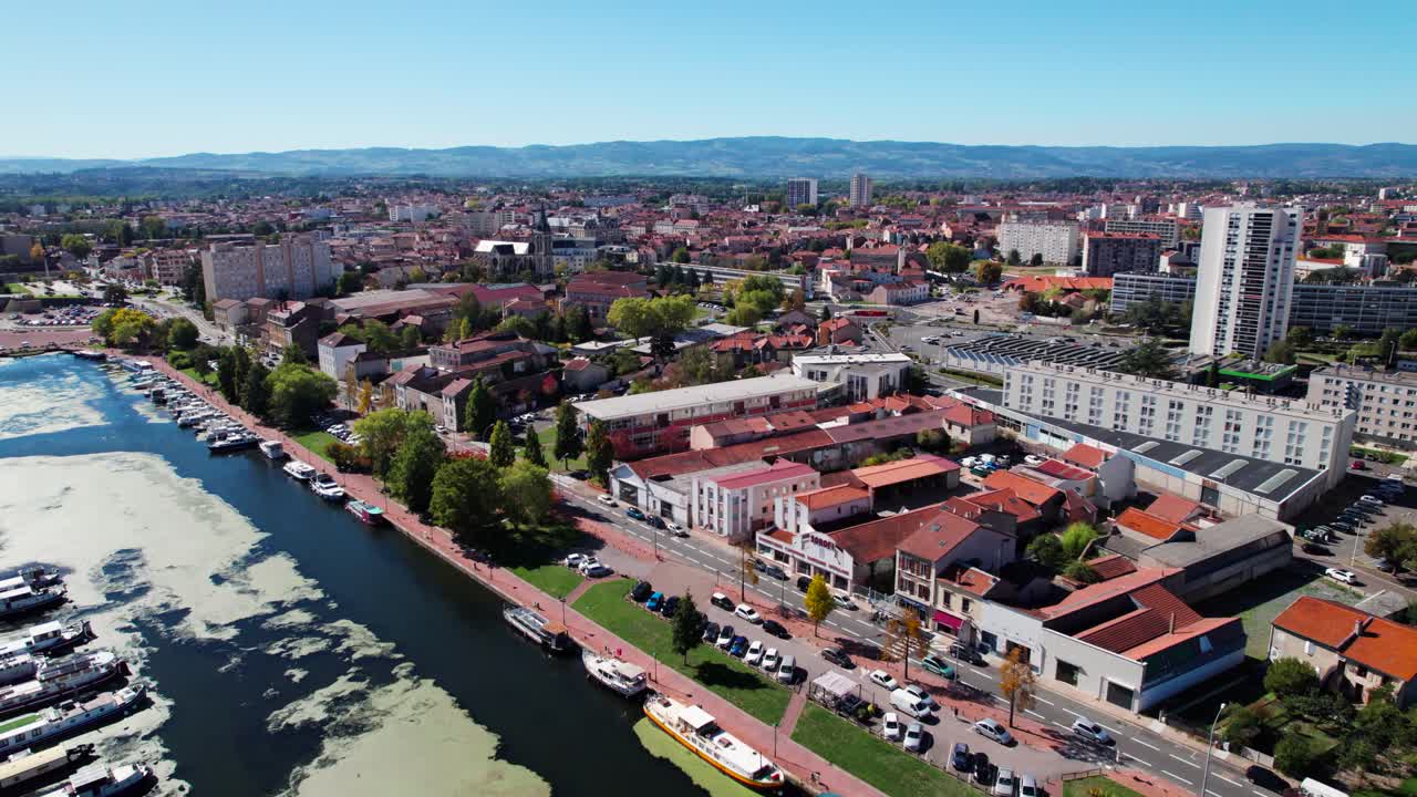 Aerial shot over Roanne city revealing the harbor and the loire river on a sunny day, Auvergne Rhone Alpes region, France