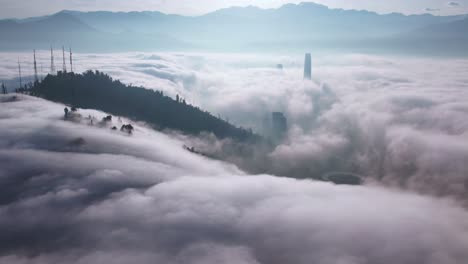 Aerial-Drone-Above-Clouds-at-San-Cristobal-Hill-Santiago,-Chile-Virgin-Mary-Peak-and-Costanera-Neighborhood,-Andean-Mountain-Range-Top