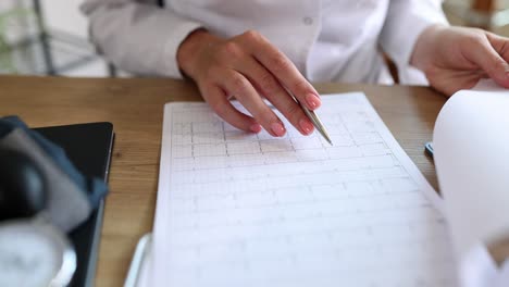 close-up of a person analyzing business data and medical documents