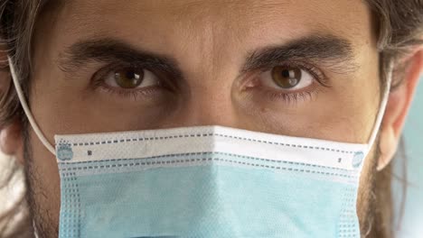 masked-man-opening-his-beautiful-brown-eyes,-Extreme-face-close-up