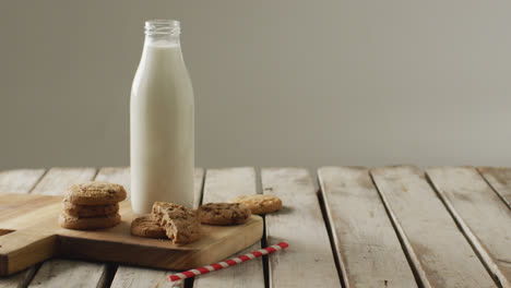 Video-of-biscuits-with-chocolate-and-milk-on-wooden-background