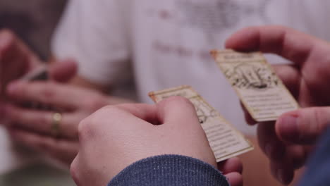 Choosing-right-card,-board-game-play,-extreme-closeup-of-hands-making-decision