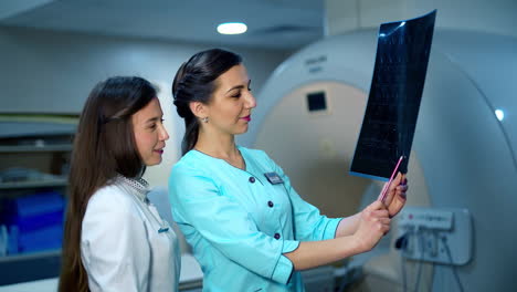 doctors with results at the laboratory. experienced professional oncologists looking at the mri scan results