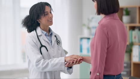 Doctor,-woman-and-holding-hand-in-office