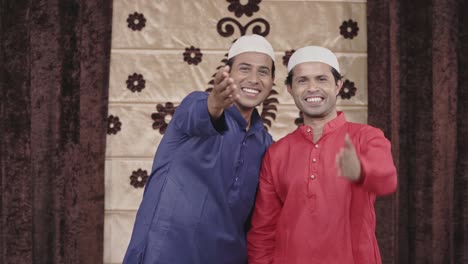 two muslim men laughing to the camera