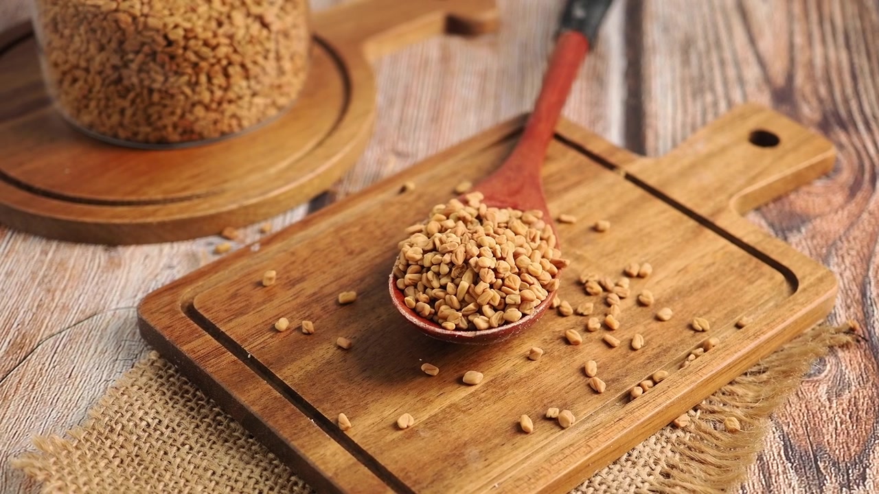 Fenugreek Seeds in a Wooden Spoon on a Cutting Board