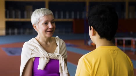 Senior-woman-talking-to-boy-indoors