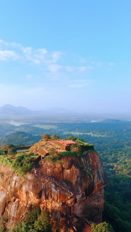 stunning mountain of sri lanka with sigiriya fortress ruins on top. well-known landmark visited by lots of tourists. aerial view. vertical video.