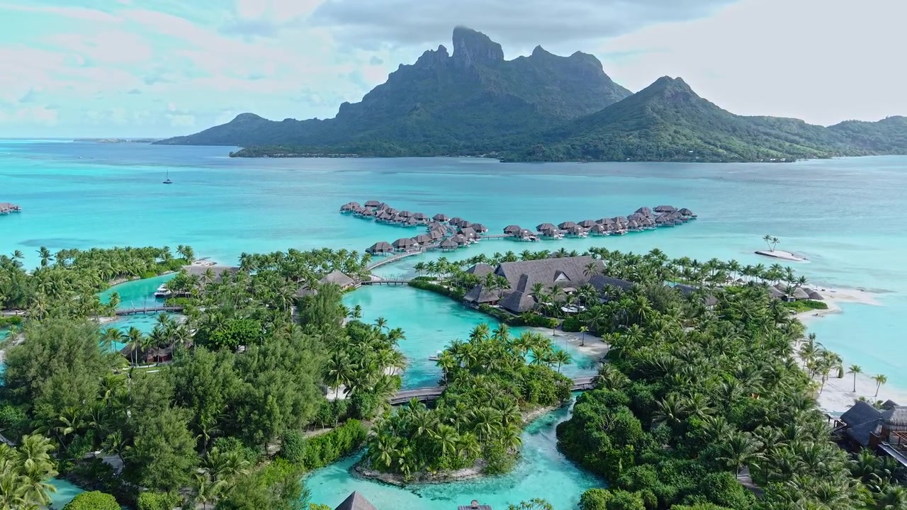 Drone Shot of Bora Bora Island, French Polynesia. Luxury Resort With Villas Above Turquoise Lagoon