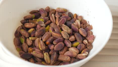 roasted pistachios in a white bowl