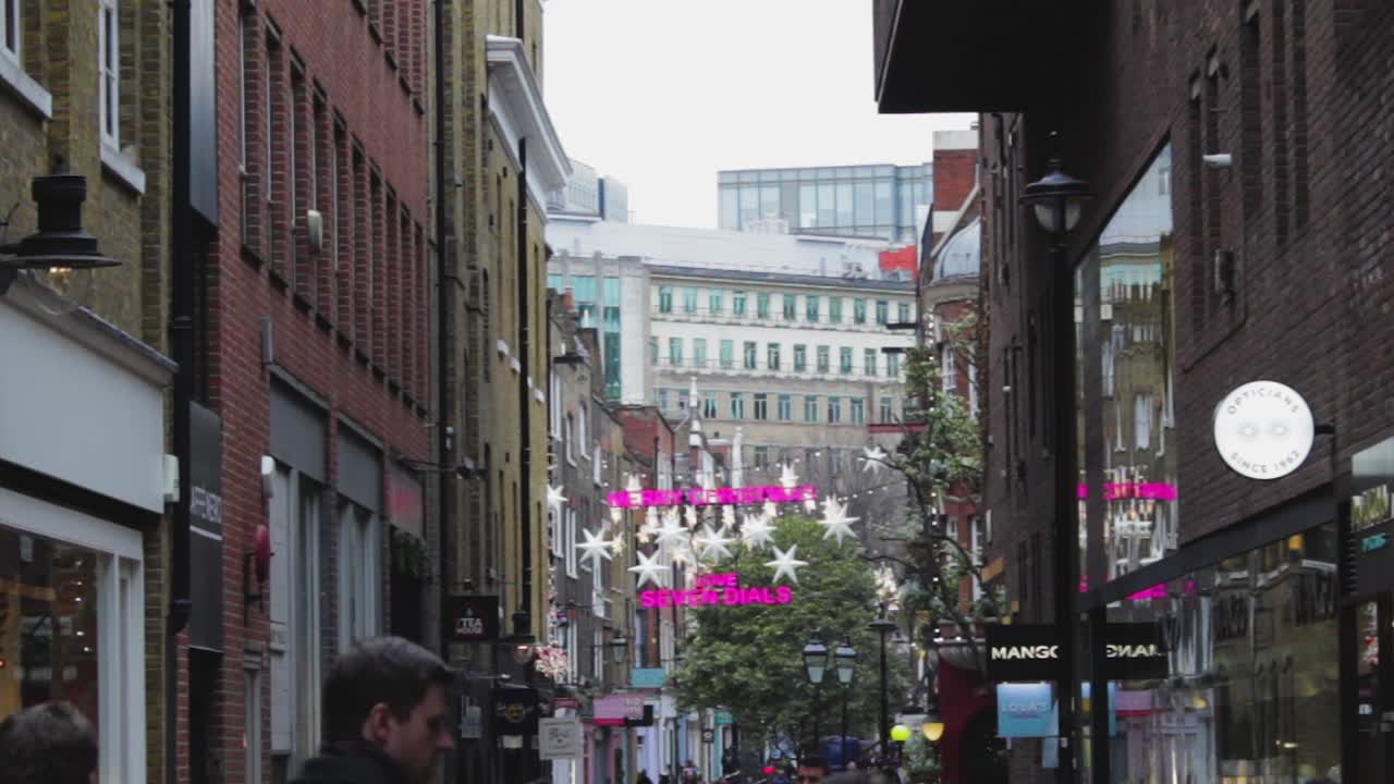 The London street at Christmas time. The light in the London street, UK United Kindom. Street view of London, Britain at holiday time with a pink yellow light on Christmas eve. POV of a street
