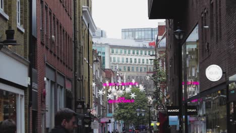 the london street at christmas time. the light in the london street, uk united kindom. street view of london, britain at holiday time with a pink yellow light on christmas eve. pov of a street