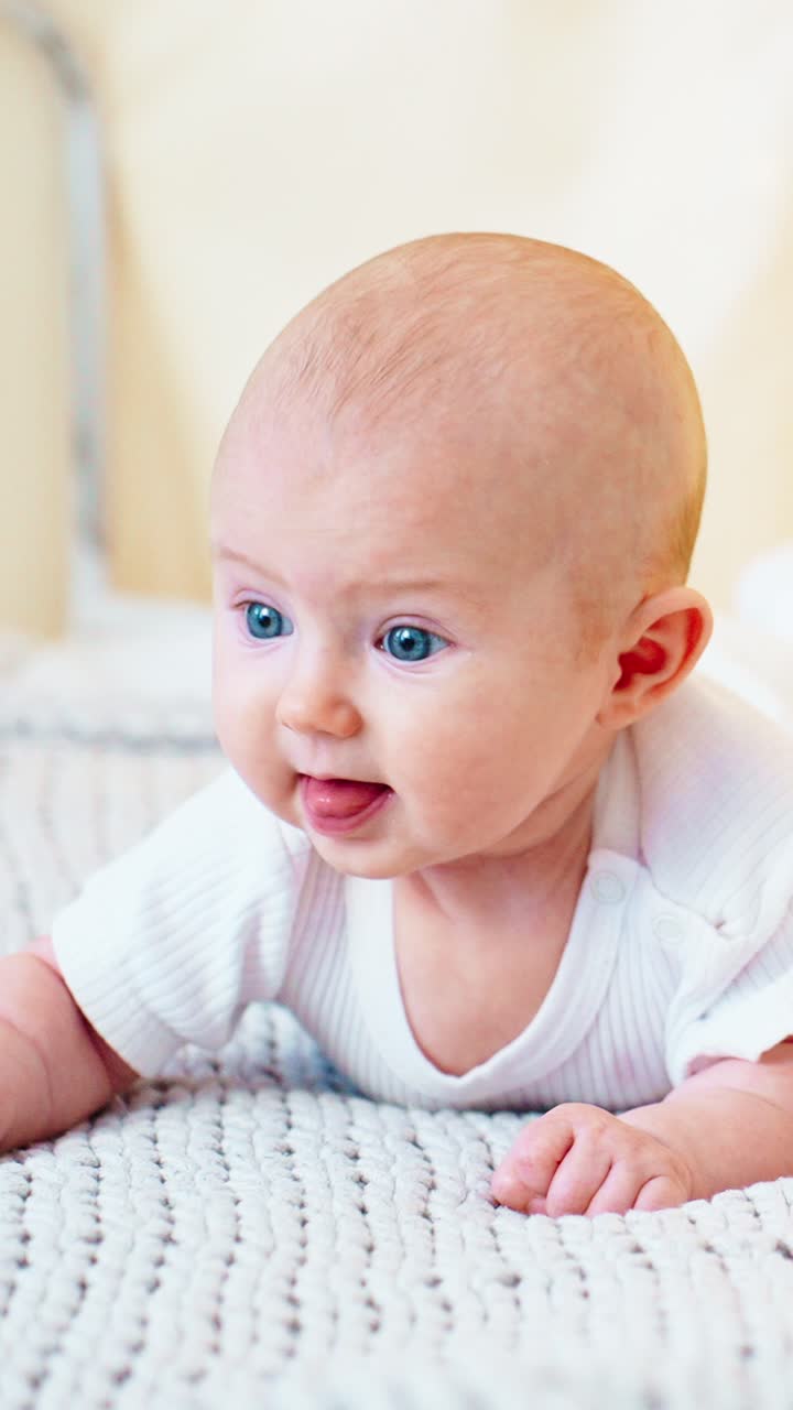 Cute Baby with Blue Eyes Doing Tummy Time and Giggling