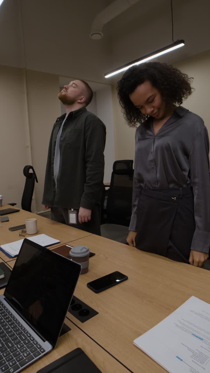 Employees Stretching During a Meeting