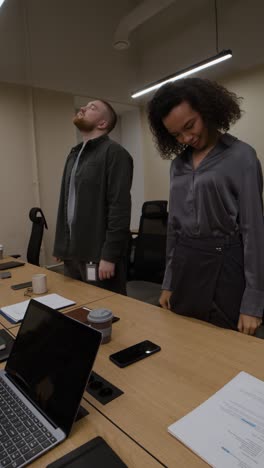 employees stretching during a meeting