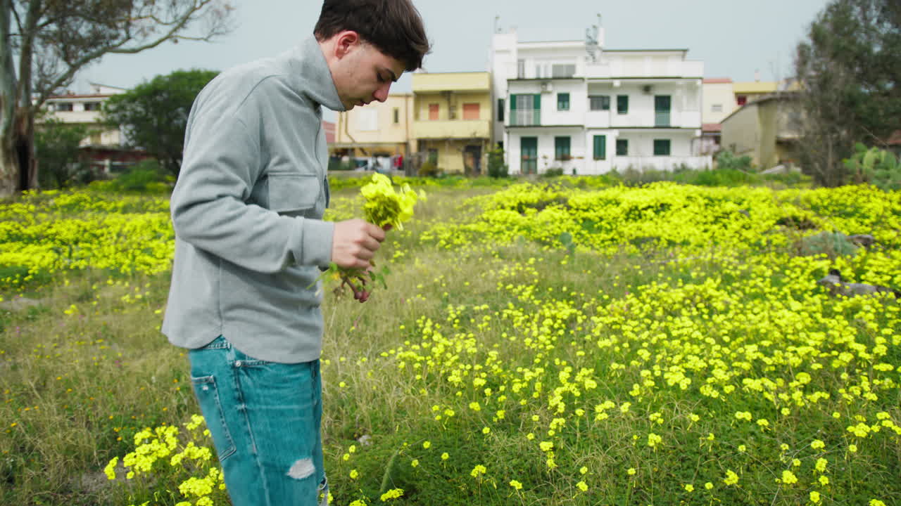 Man Selecting And Picking Yellow Flowers For Mothers Day Gift