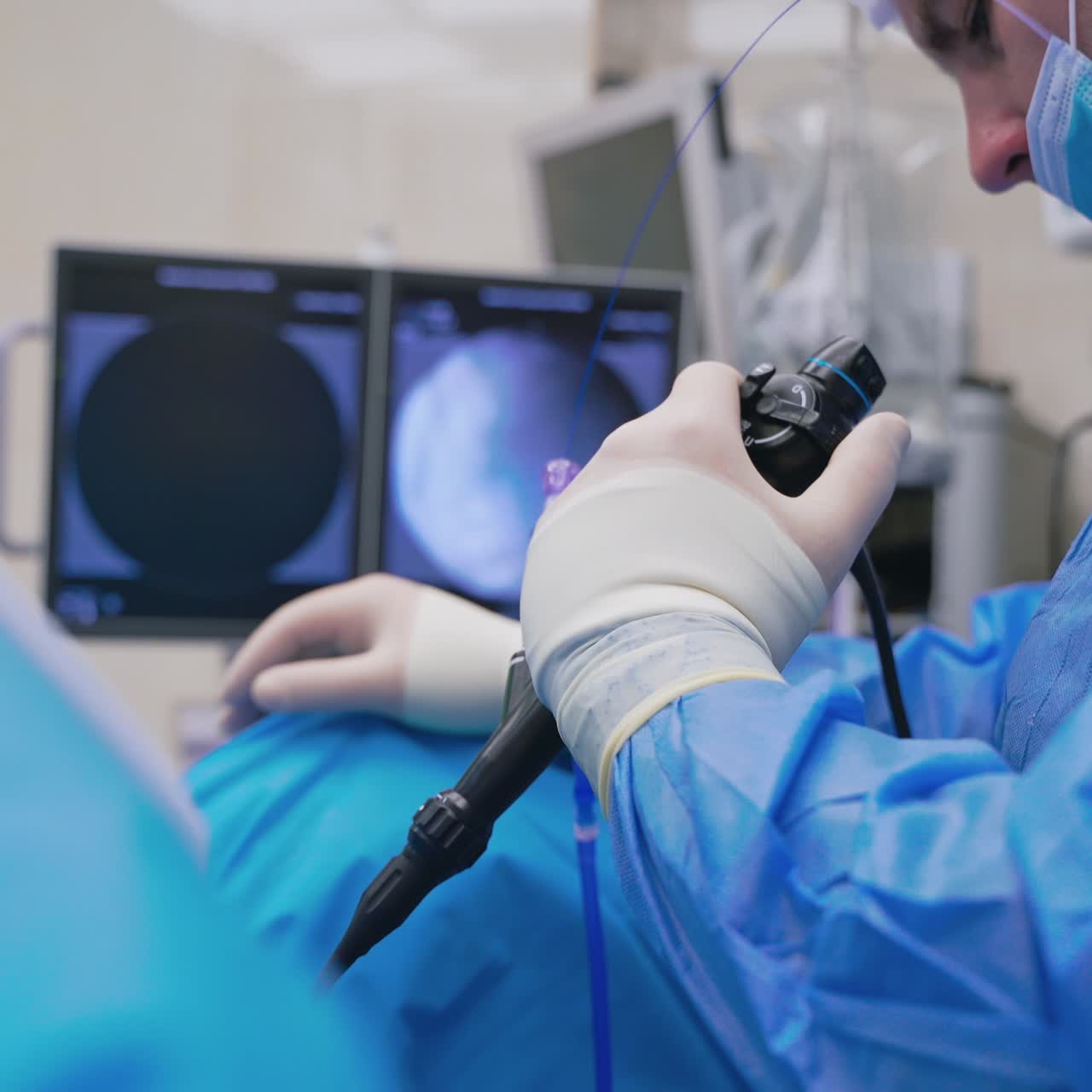 Doctor uses innovative equipment in operating room. Surgeon holds modern instrument on monitors background in clinic. Modern technologies in medicine.