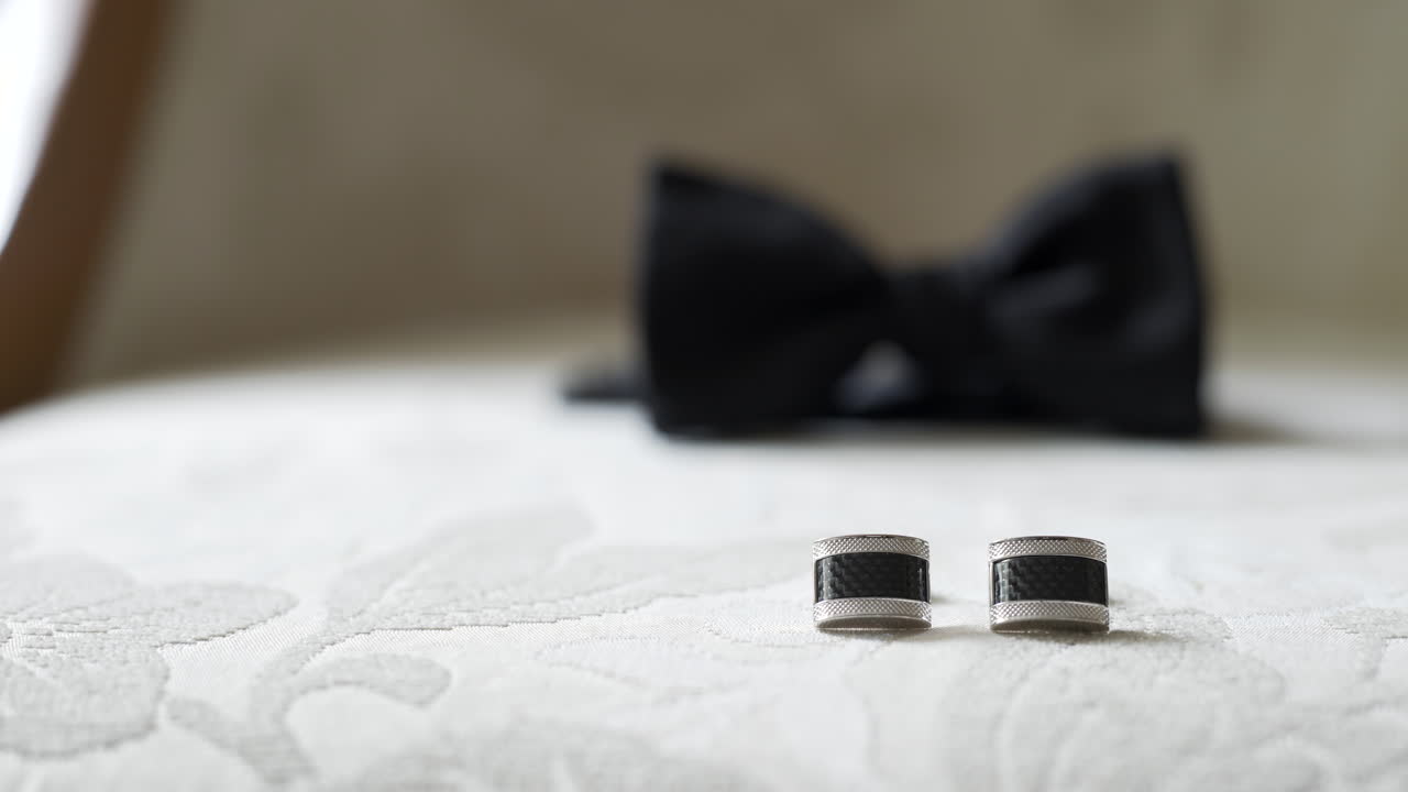 Elegant Cufflinks and Bow Tie on a Textured Surface