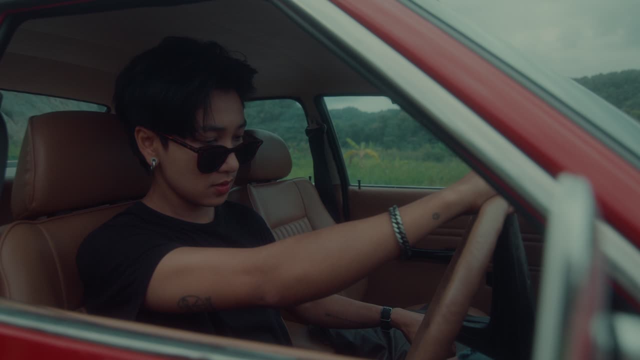 Man Driving a Vintage Red Car