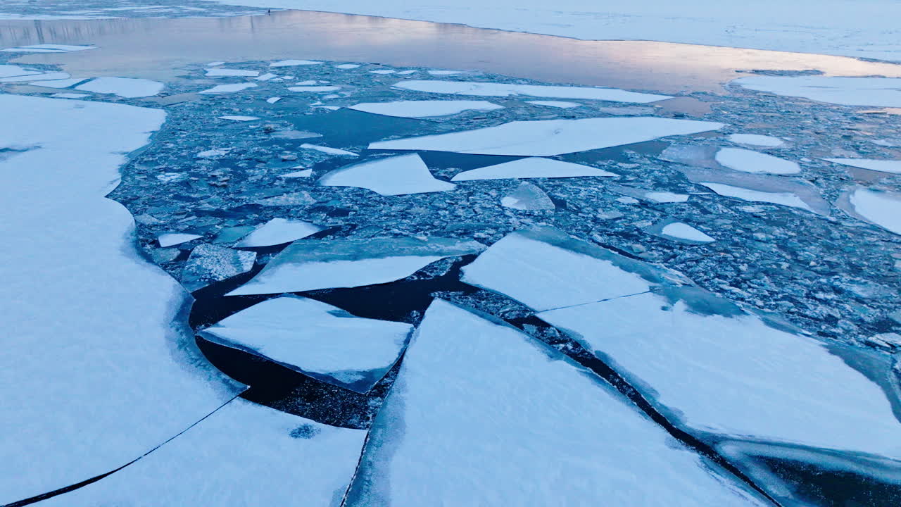 A drone's viewpoint exploring the intricate world of gigantic ice floes on the water
